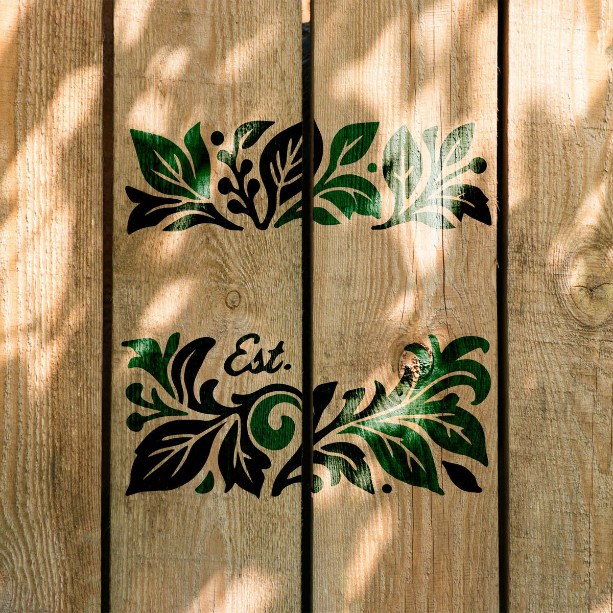 Family Name & Established Date stencil with botanical flourishes painted on rustic wood