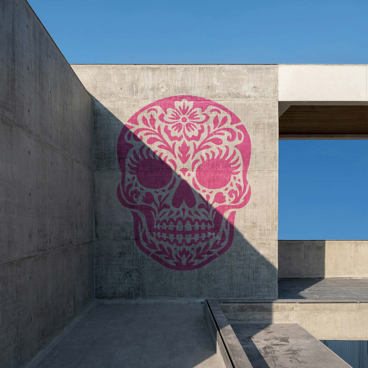 Oversized Female Sugar Skull Stencil stands out in pink across a modern concrete wall