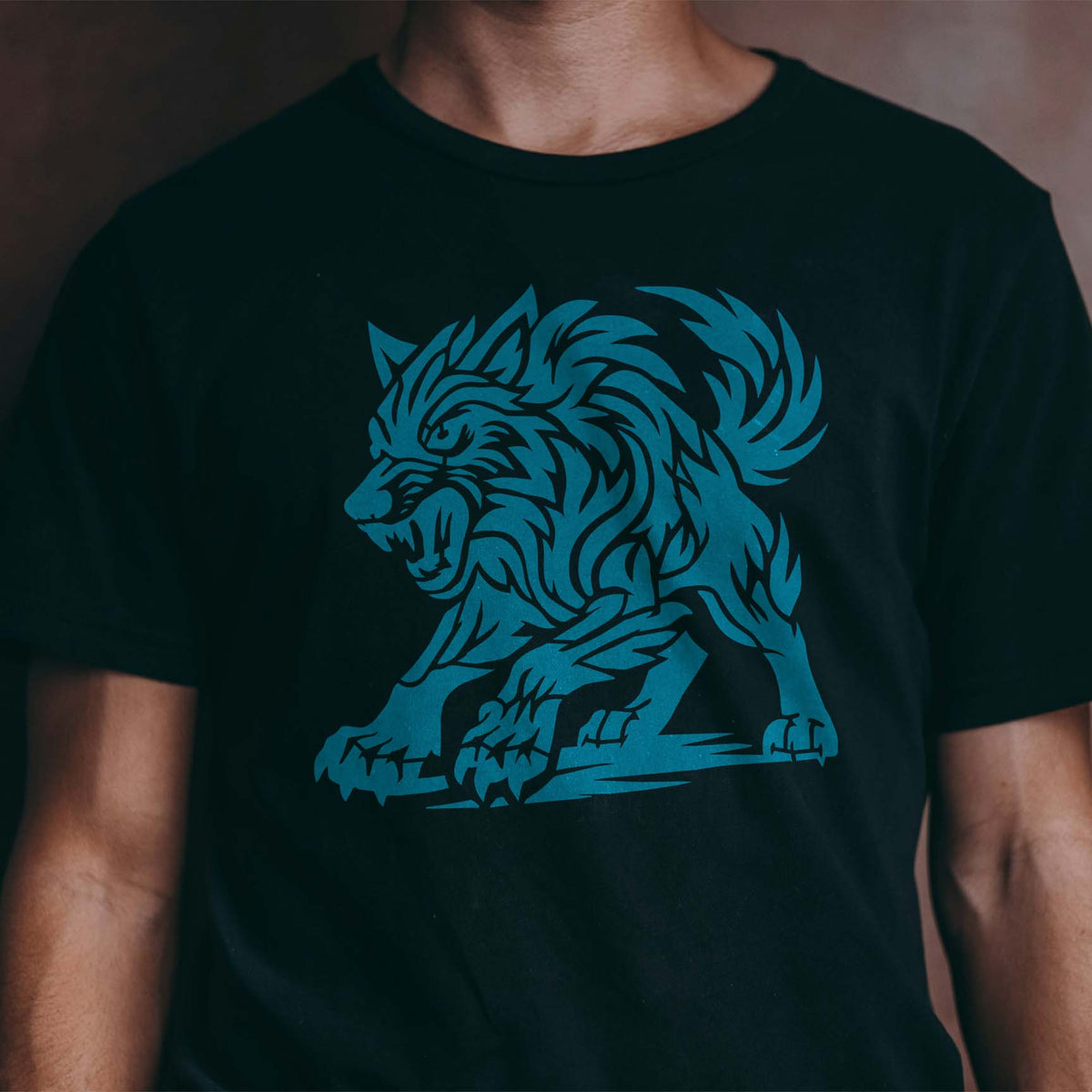 Fierce Tribal Wolf Stencil shows a snarling blue wolf with sharp claws on a black T-shirt.