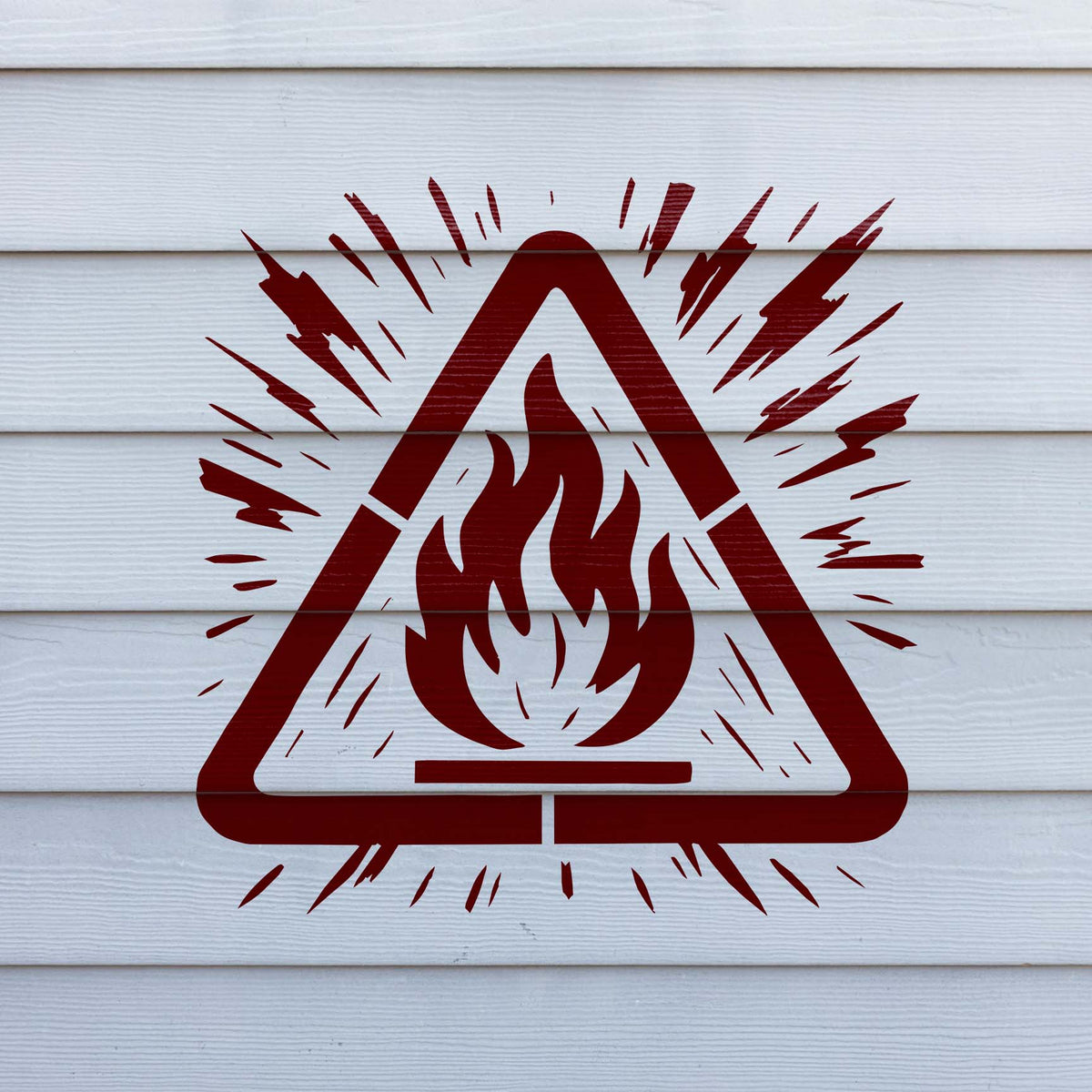Painted across white siding, the Flammable Hazard Warning Stencil features a vivid red fire symbol.