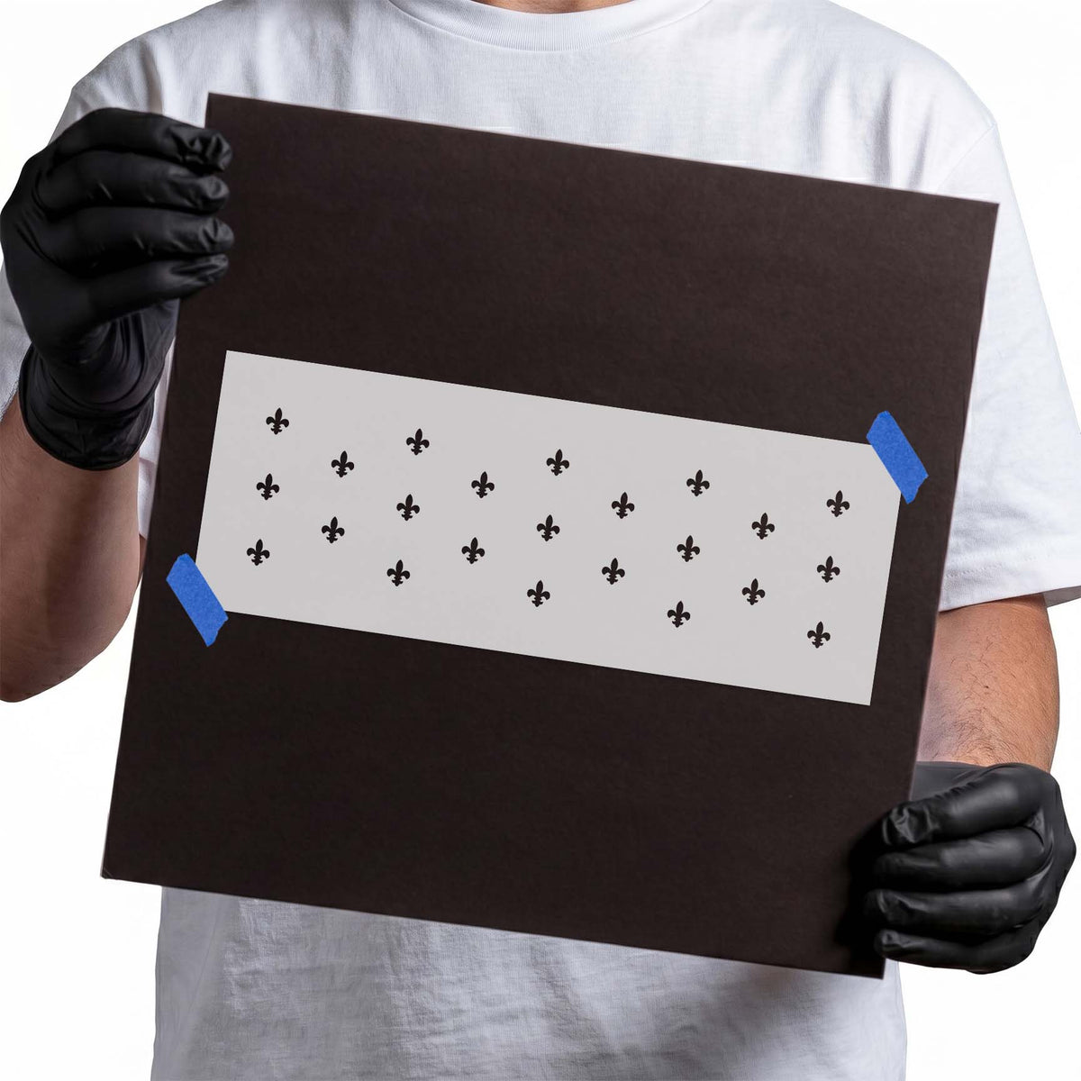 Explore the Fleur de Lis Pattern Stencil in a repeating border layout on a held sample board.