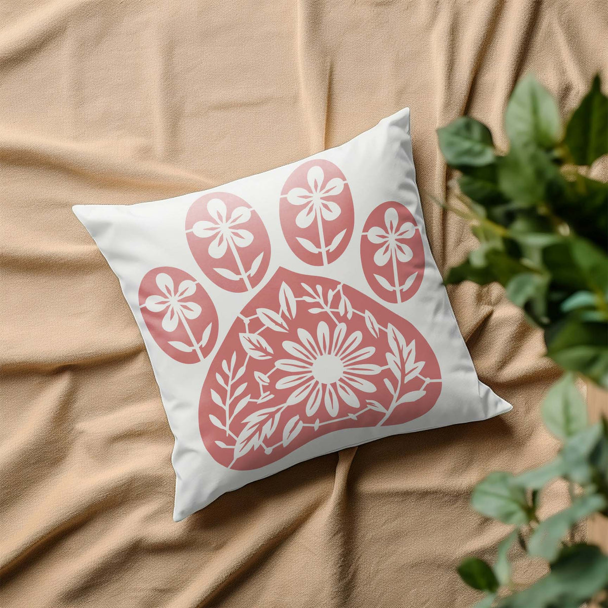 Floral Dog Paw Print Stencil blooms in soft pink across a white decorative pillow