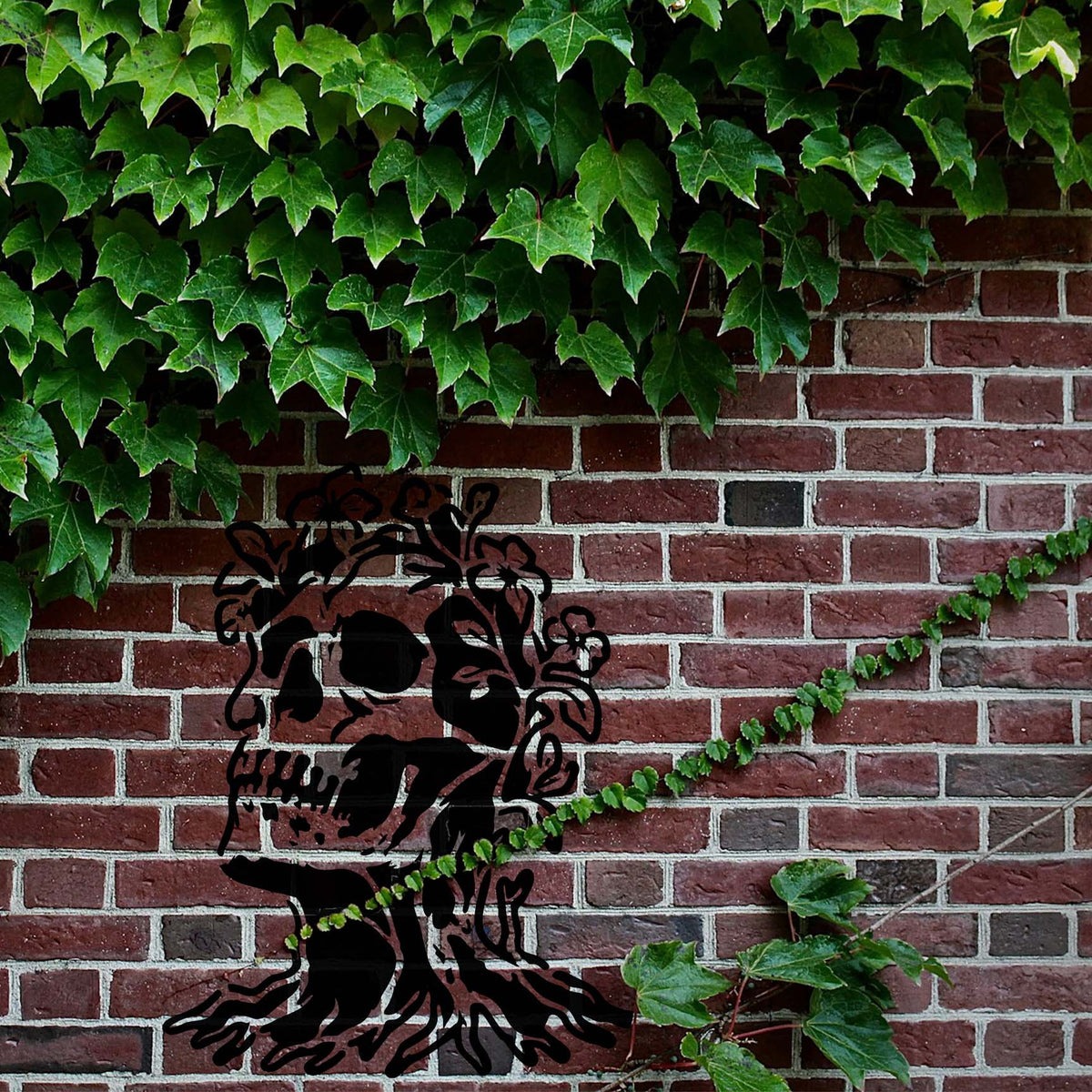 Floral Skull Tree Stencil forms a haunting skull tree among ivy on a rustic brick wall