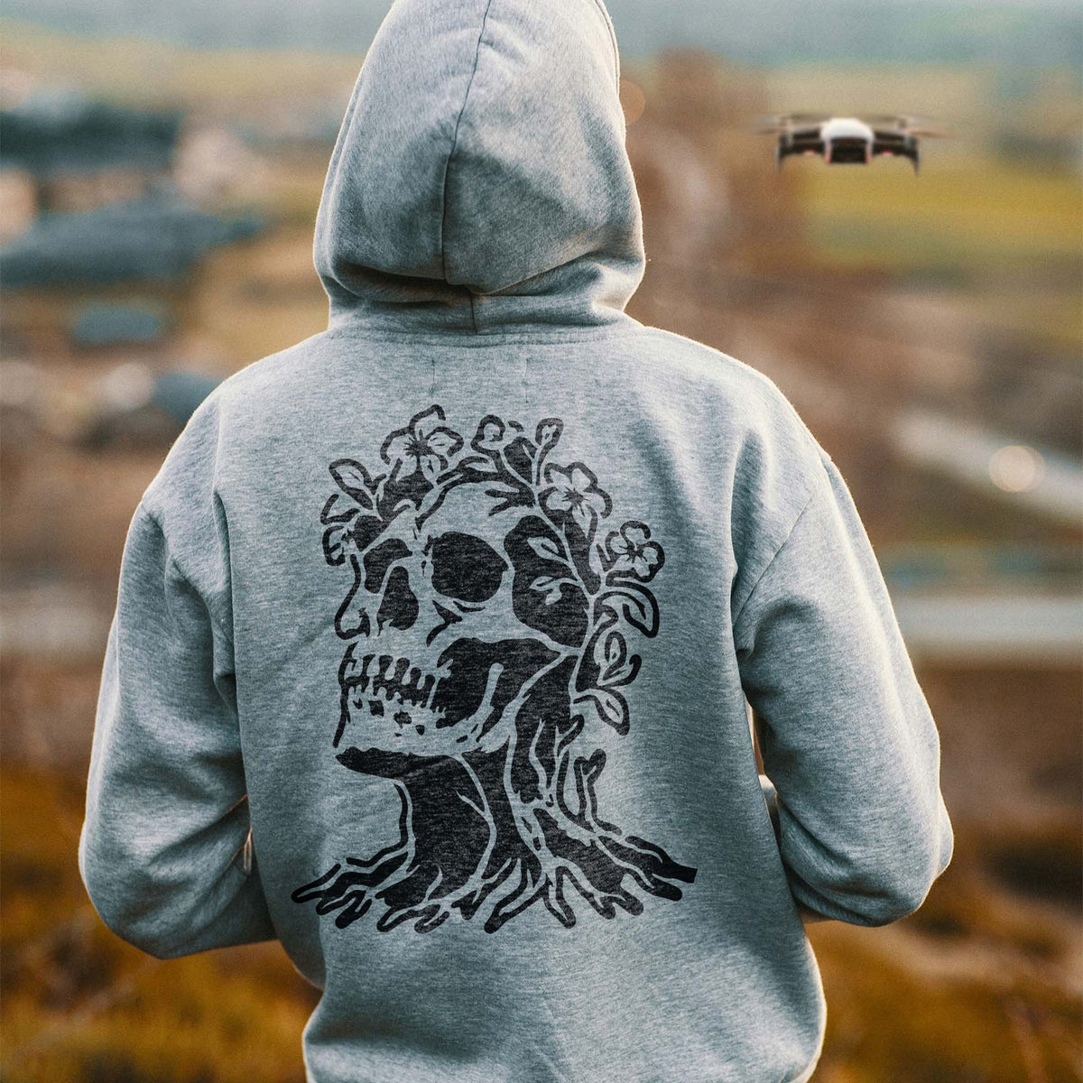 Floral Skull Tree Stencil brings twisted roots and blossoms to the back of a gray hoodie