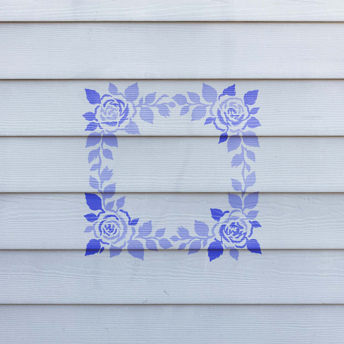 Floral Wedding Border stencil with purple roses painted across white siding