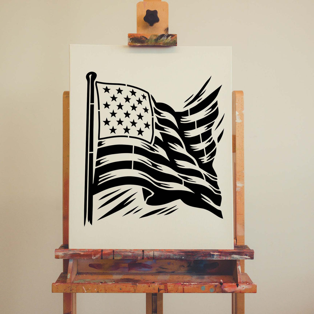 Displayed on an easel, the Flowing American Flag Stencil features dramatic waving stars and stripes