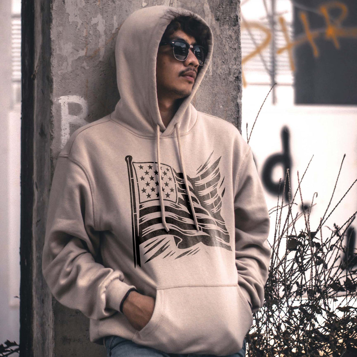 Across a beige hoodie, the Flowing American Flag Stencil shows sweeping stars and windswept stripes
