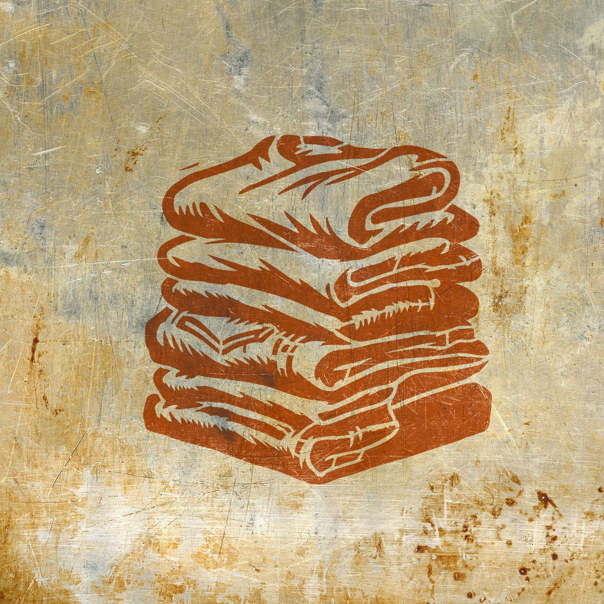 Folded Laundry Stack stencil painted orange on distressed metal surface