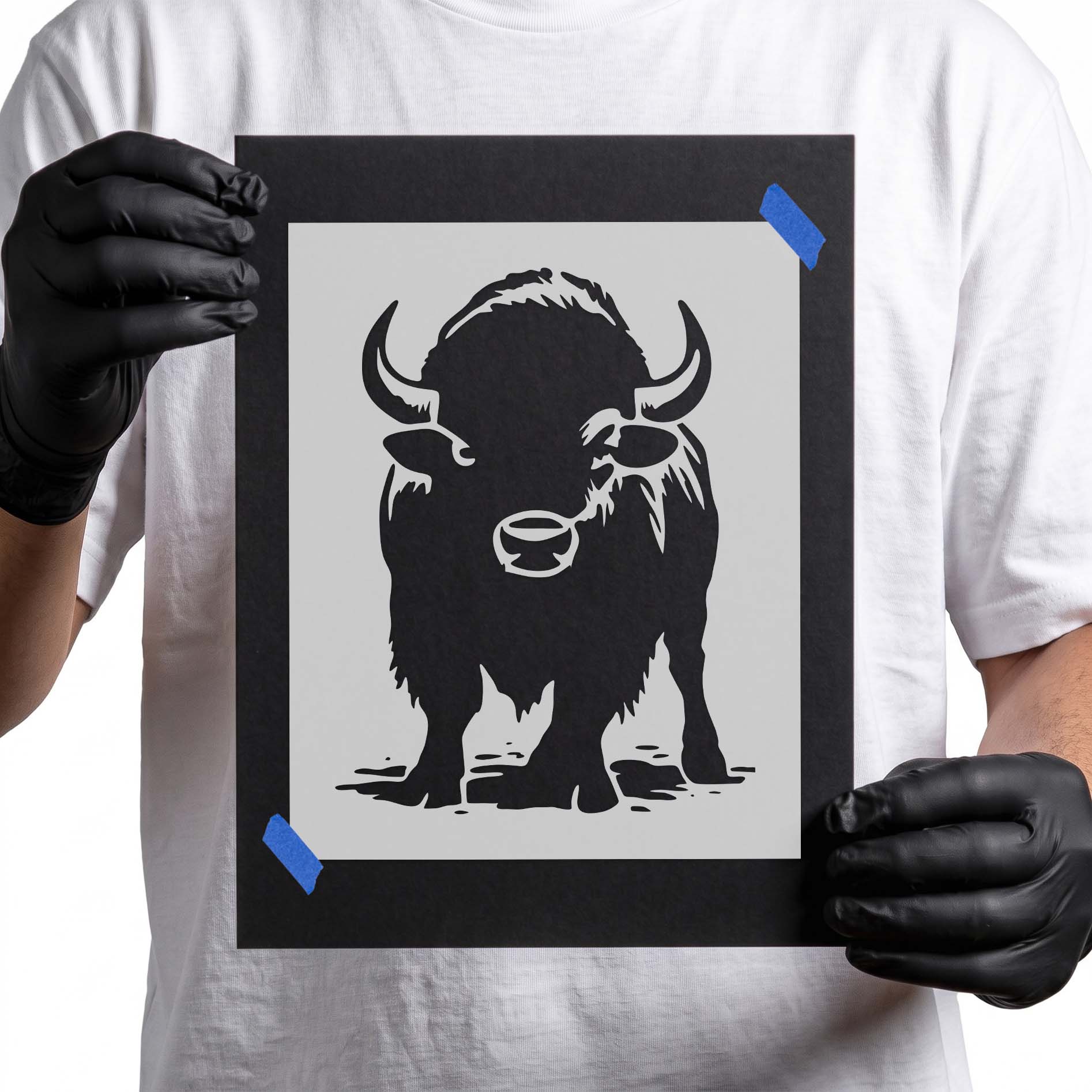 Front facing bison stencil with curved horns and shaggy coat

