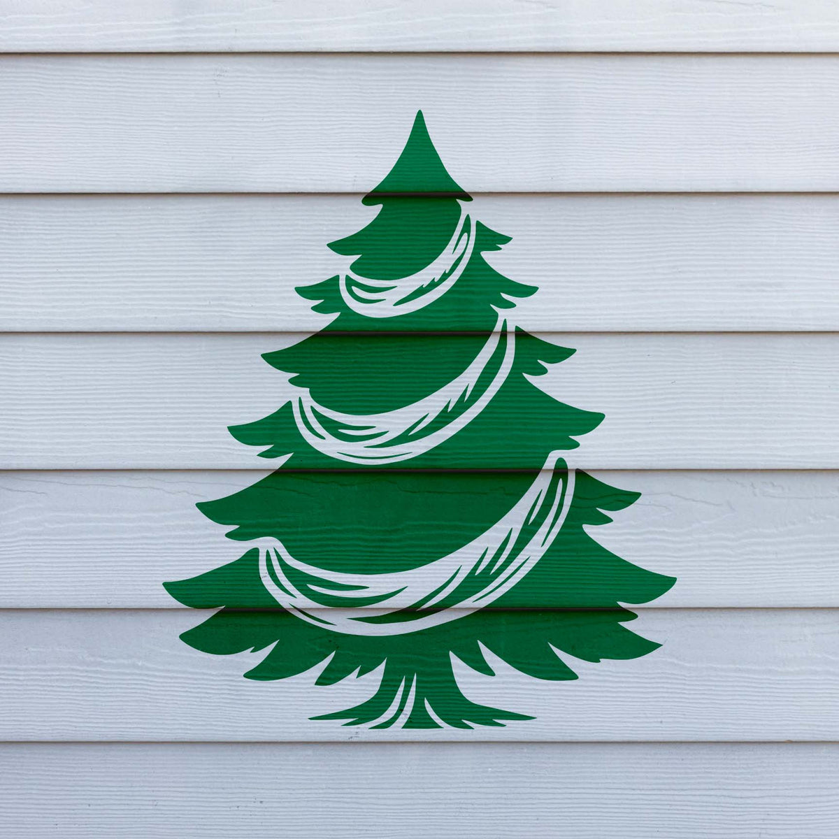 Garland Christmas Tree Stencil displayed in green on white siding panels.