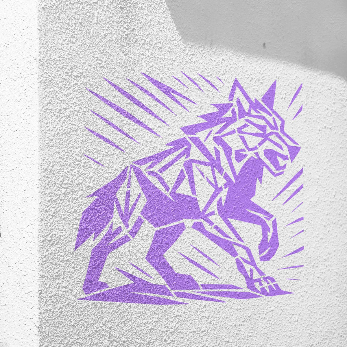 A textured white wall showcases the Geometric Howling Wolf Stencil in a striking purple finish.