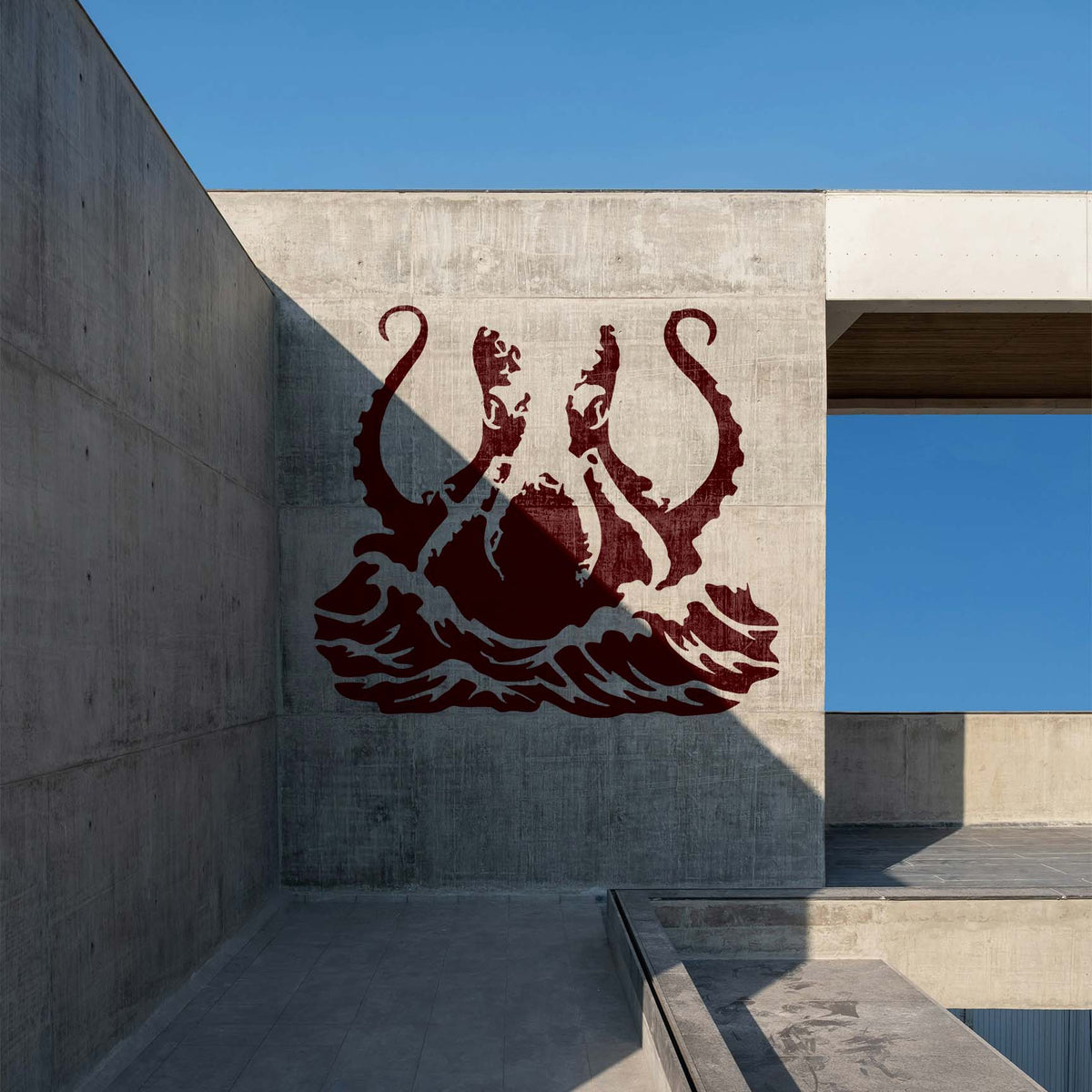 Giant Octopus Tentacles Stencil rises from stylized ocean waves on a concrete wall