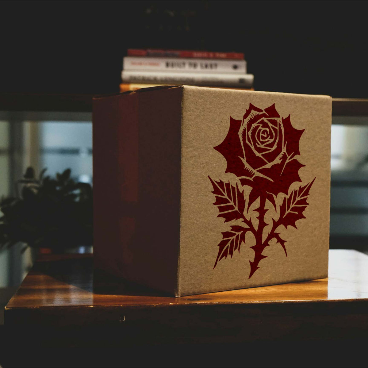 Gothic Rose Bloom Stencil displayed in red on a kraft cardboard box.