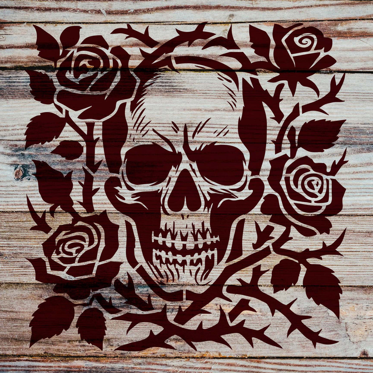 Thorny roses frame the Gothic Skull and Thorned Roses Stencil painted on rustic wood