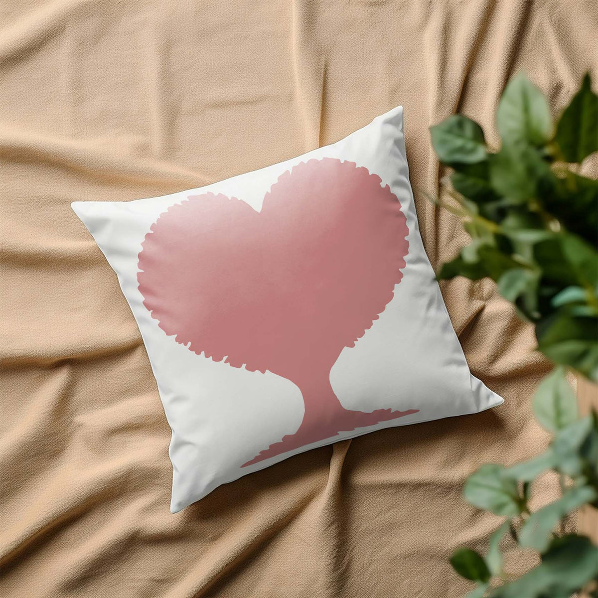 Heart Shaped Tree Silhouette stencil displayed in pink on a white pillow