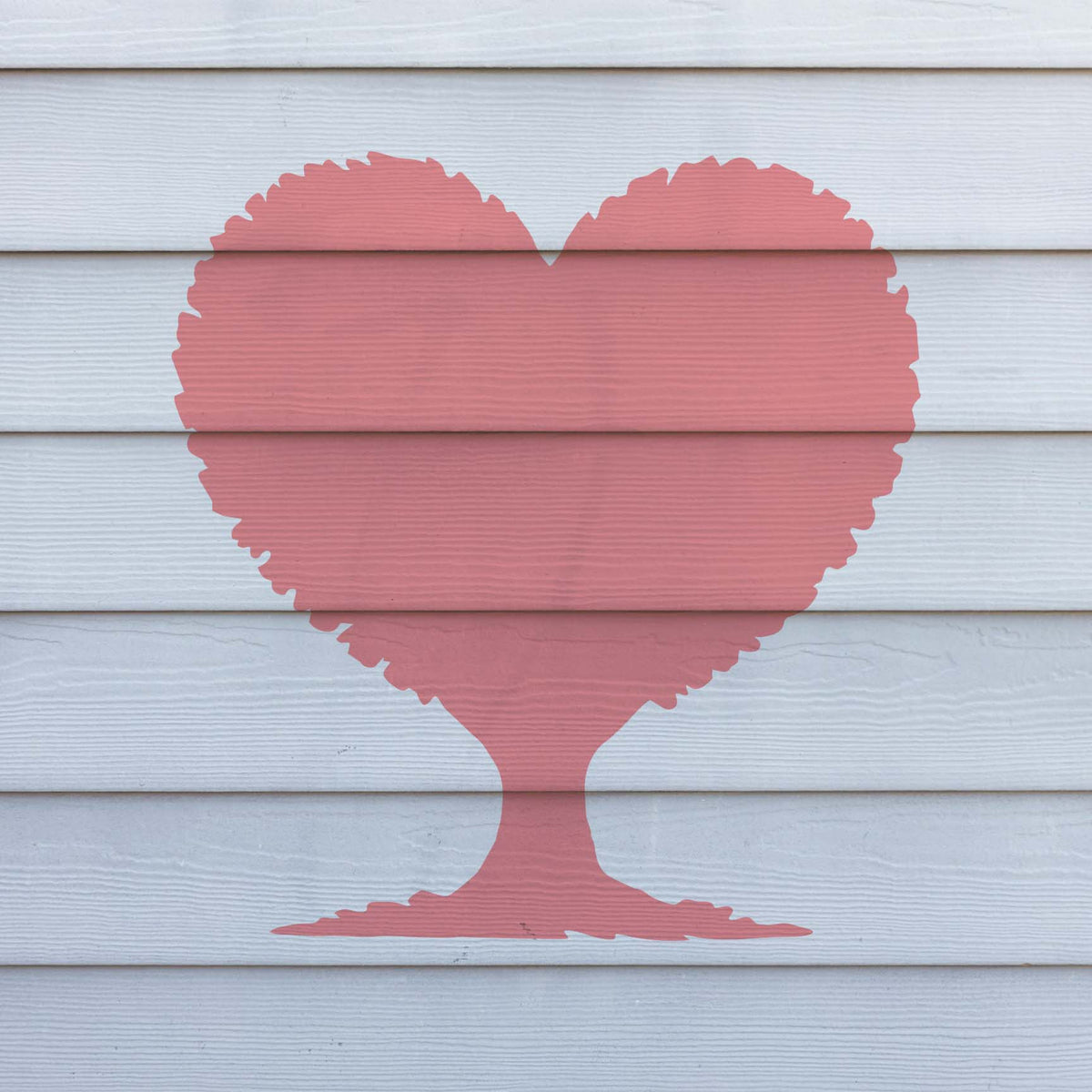 Heart Shaped Tree Silhouette stencil shown in pink on white exterior siding