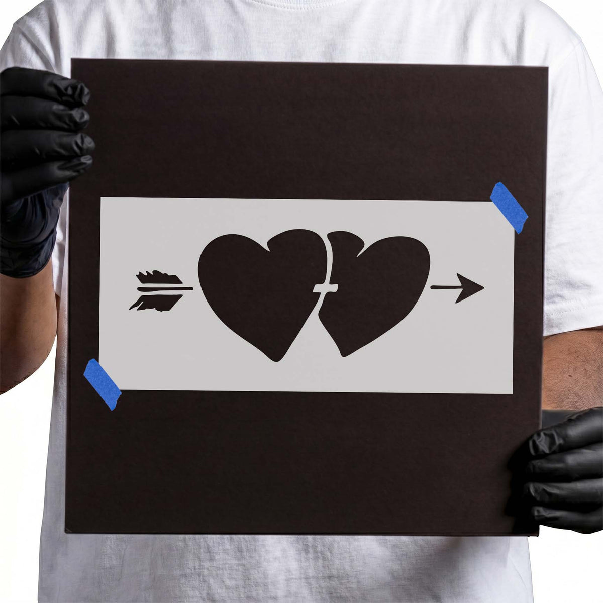 Two hearts with arrow stencil featuring a central split, feathered tail, and pointed arrowhead