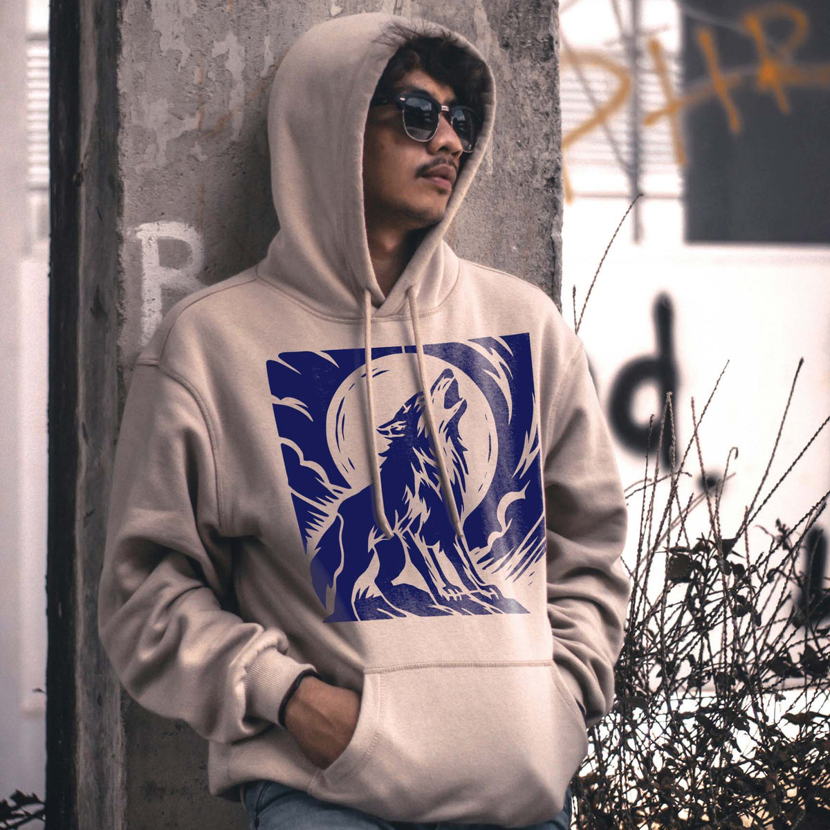 A beige hoodie features the Howling Wolf Moon Scene Stencil in a striking deep blue print.
