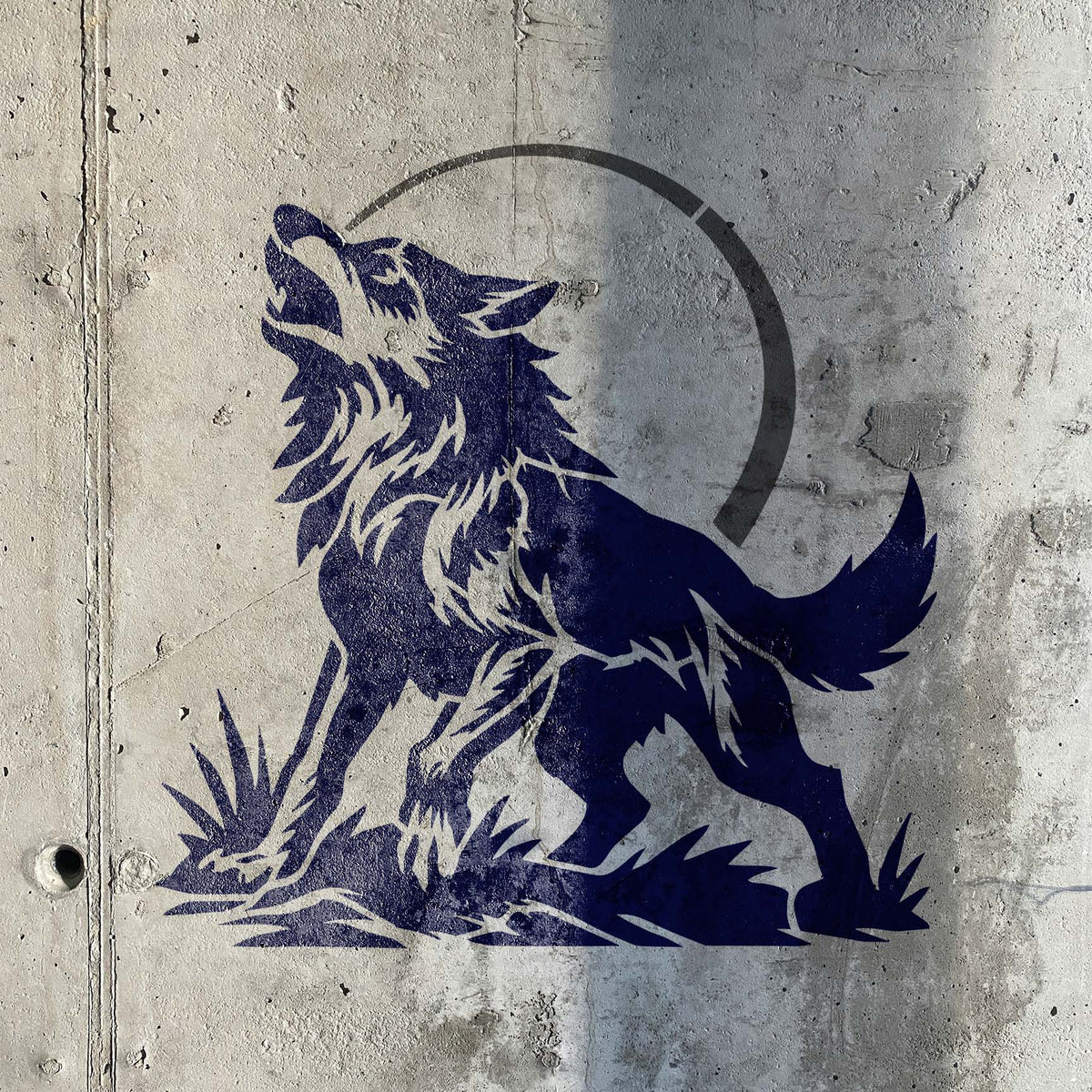 Howling Wolf Under Moon Stencil painted in blue on concrete wall