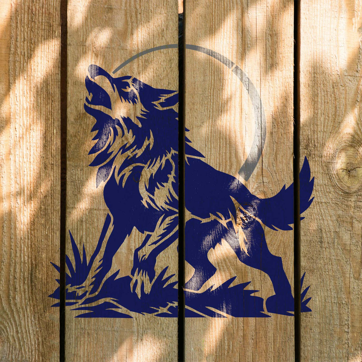 Howling Wolf Under Moon Stencil painted in blue on wooden boards