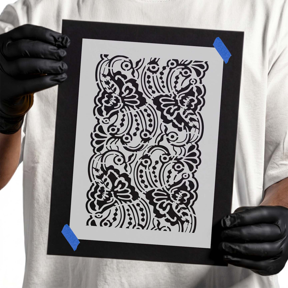 Lace stencil with ornate floral shapes, sweeping curves, and dotted details