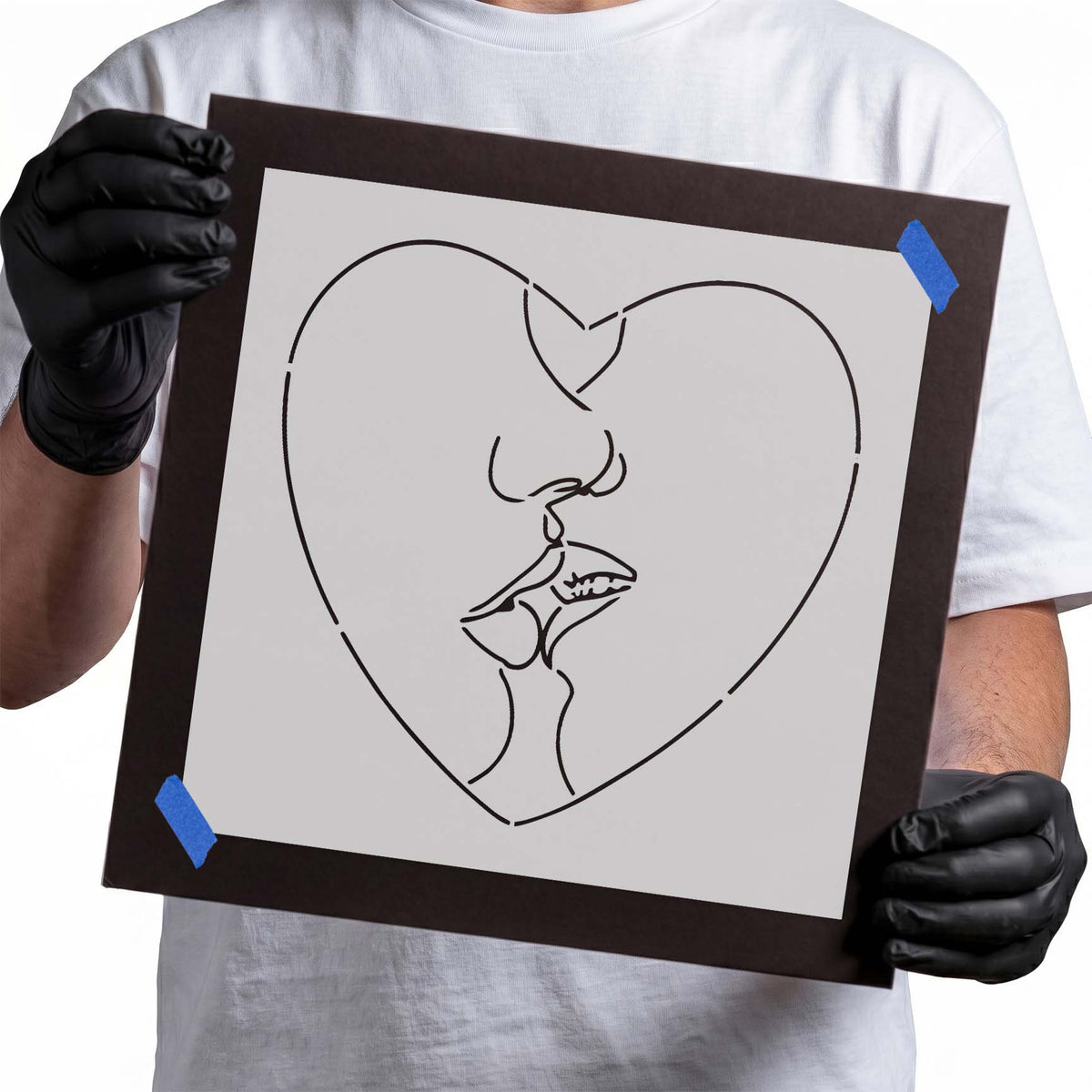 Kissing heart stencil featuring two faces sharing a kiss within a curved heart outline