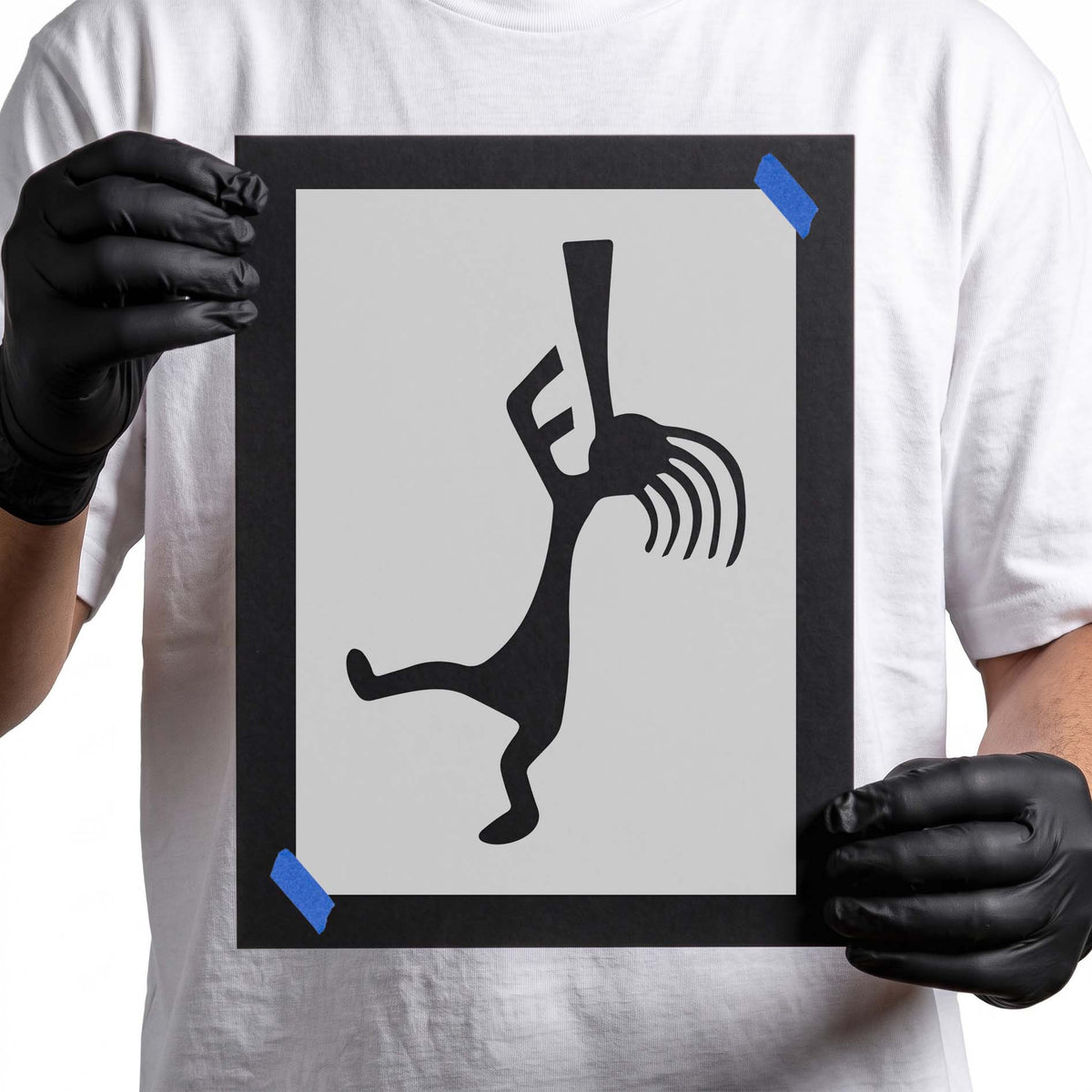 Kokopelli stencil showing a stylized figure playing a long flute