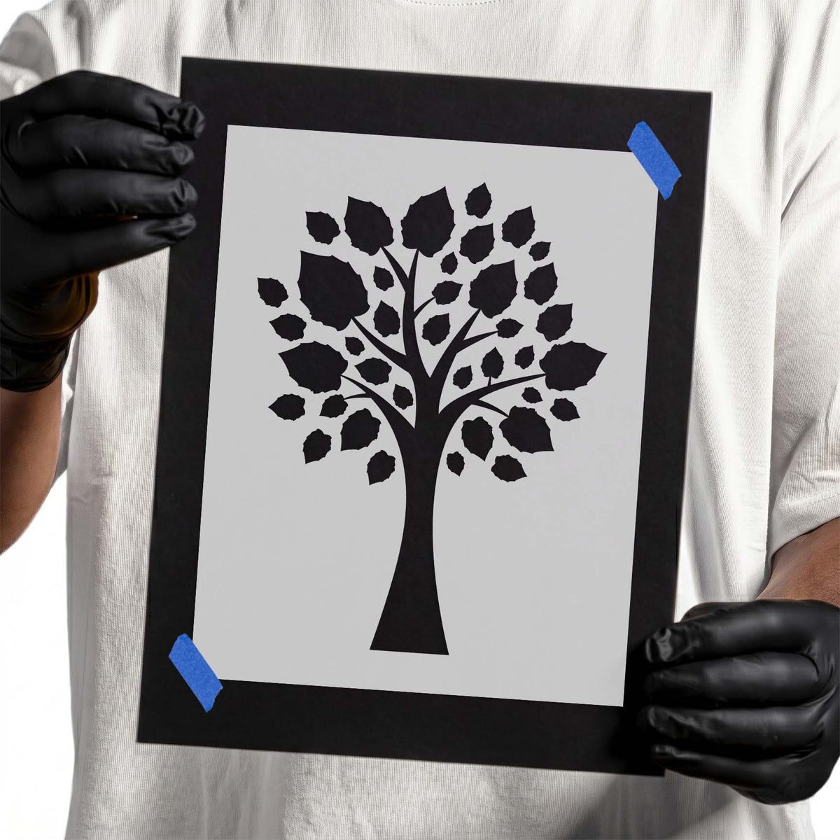 Tree stencil with branching trunk and scattered leafy canopy