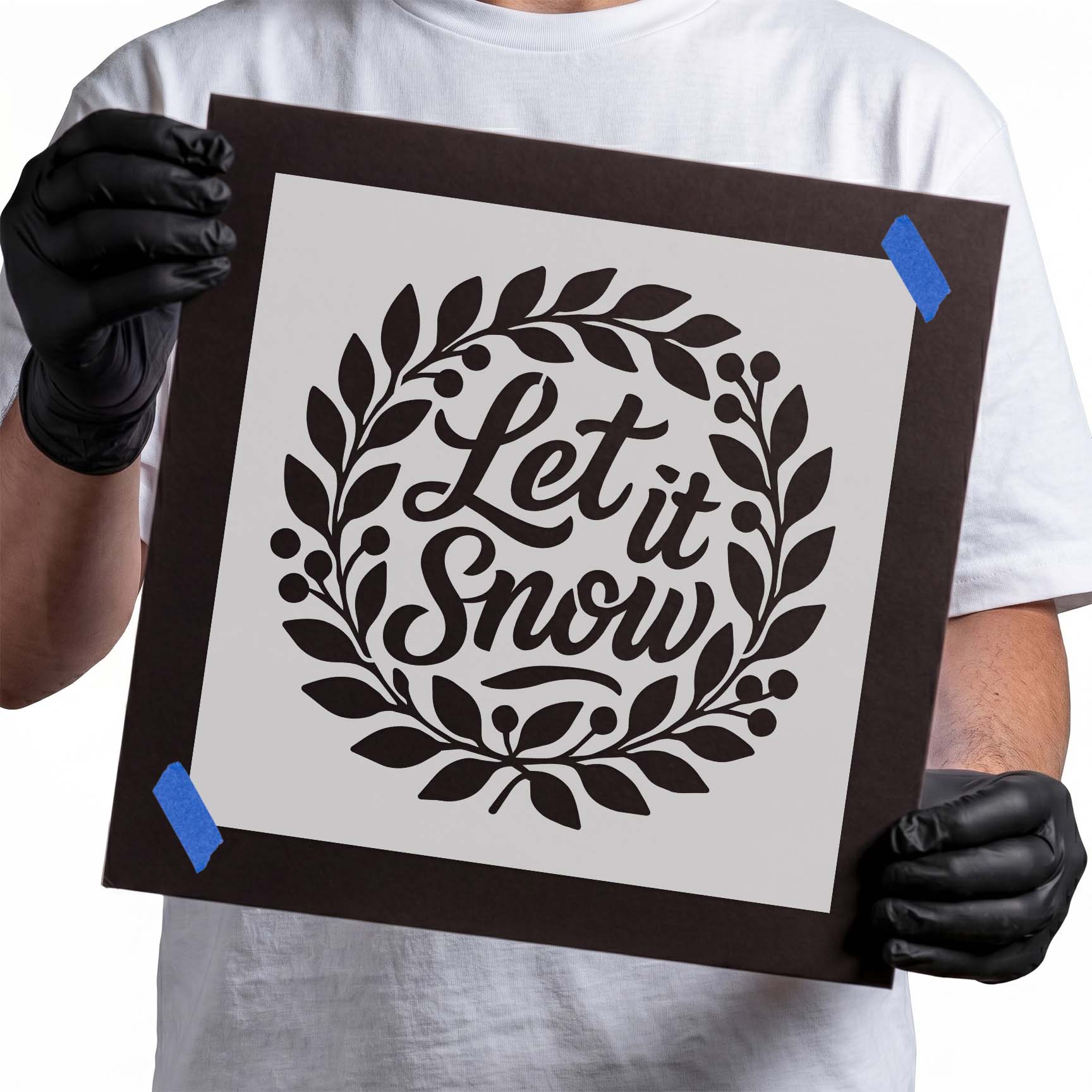 Let It Snow lettering stencil inside a leafy holiday wreath with berries