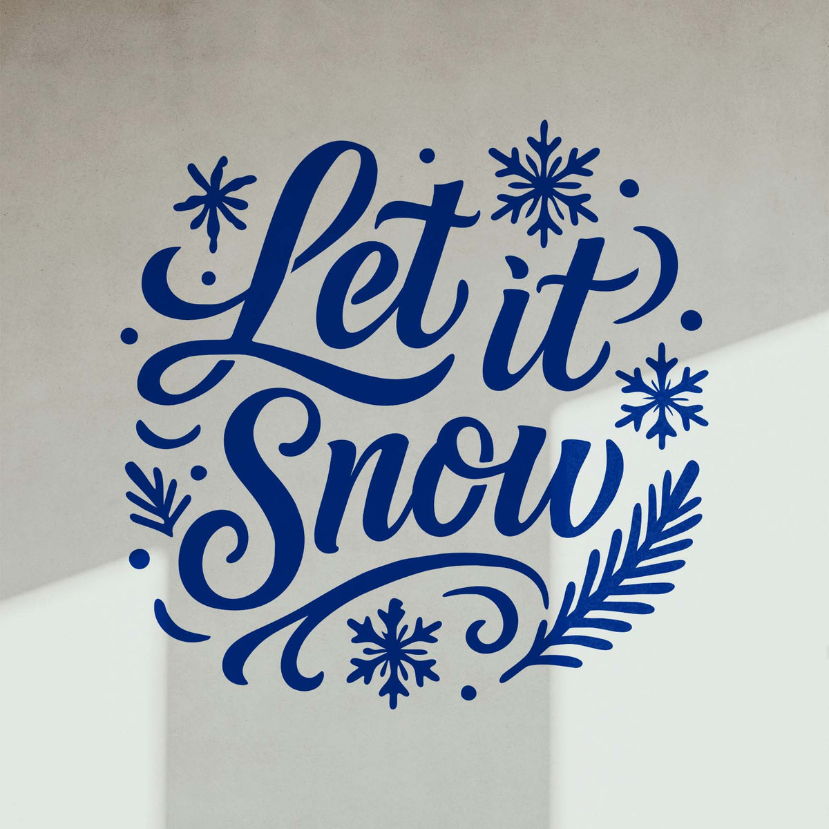 Let It Snow Holiday Stencil appears in bold blue script with snowflakes on a light interior wall.