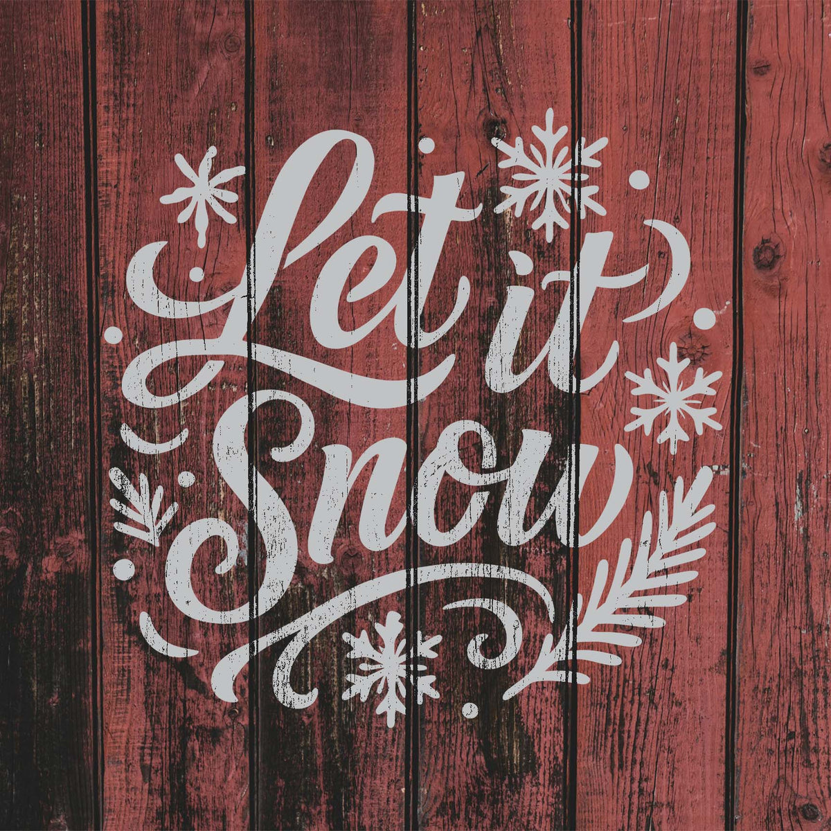 White Let It Snow Holiday Stencil lettering brings snowflakes and winter accents to rustic red wood.