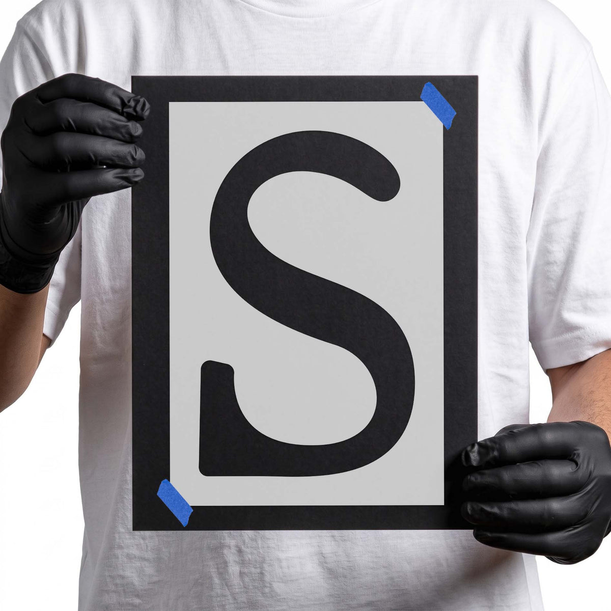 Uppercase letter S stencil featuring thick rounded strokes and sweeping decorative curves