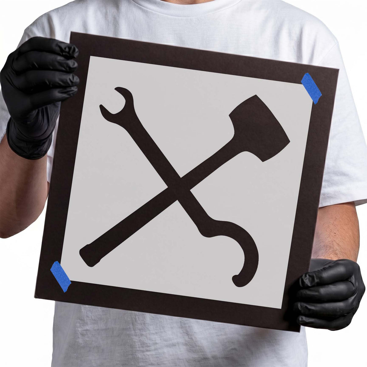Maintenance symbol stencil showing a crossed open-end wrench and axe silhouette