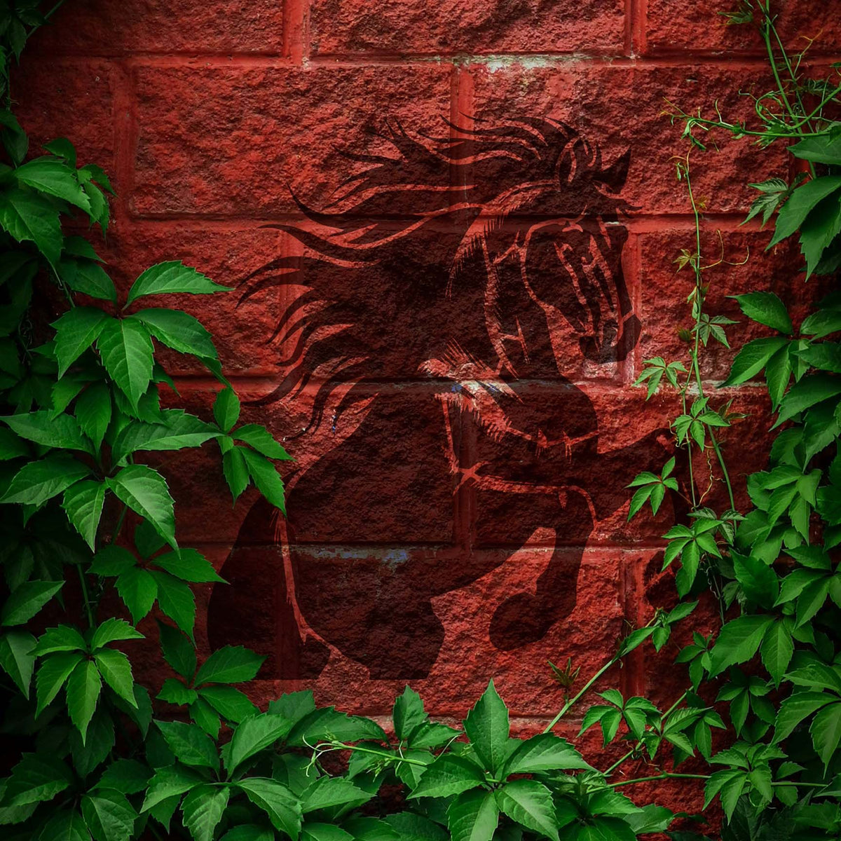Majestic Rearing Stallion Stencil depicts a powerful horse rising against an ivy-framed brick wall.