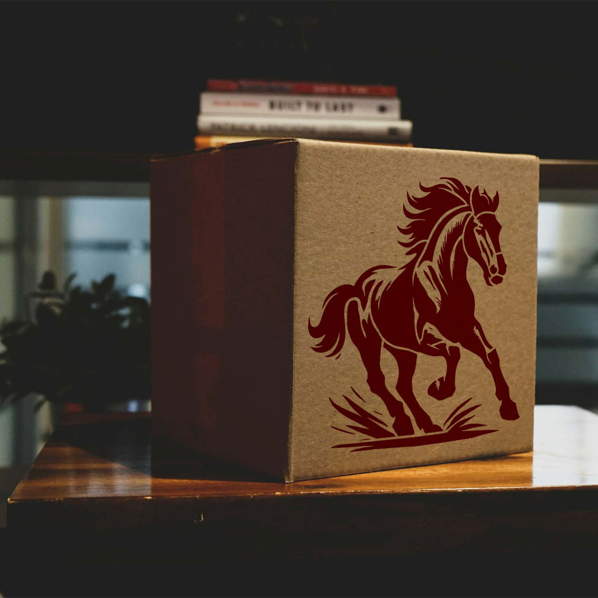A galloping Majestic Running Horse Stencil in deep red adorns a kraft cardboard box with flowing mane and tail.