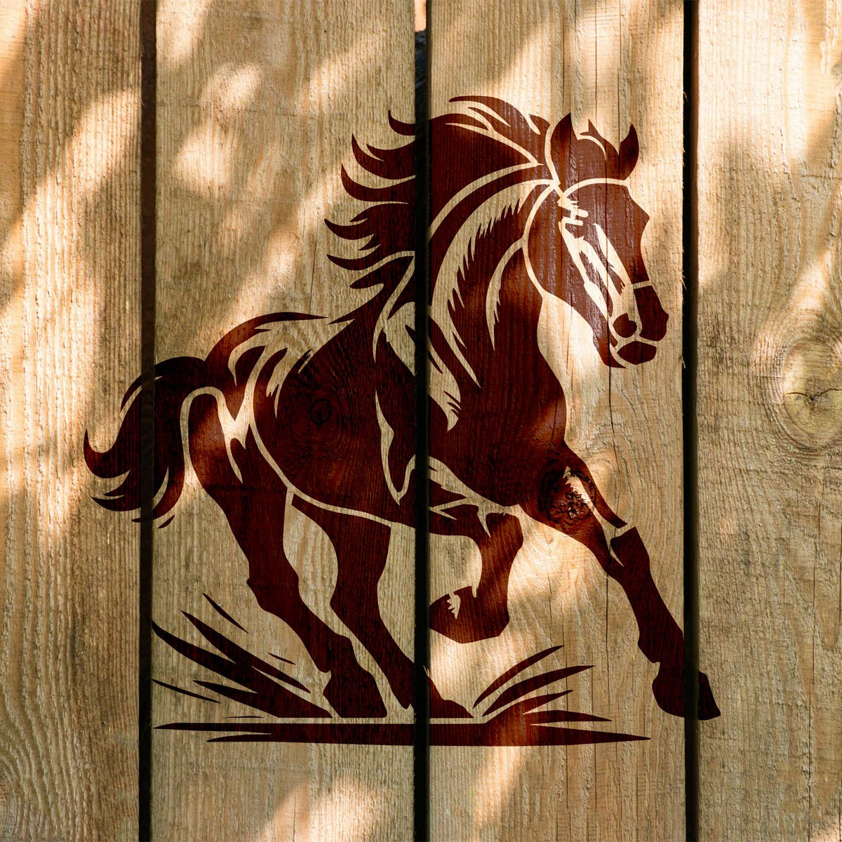 Flowing mane and raised hooves define the Majestic Running Horse Stencil painted on rustic wooden planks.