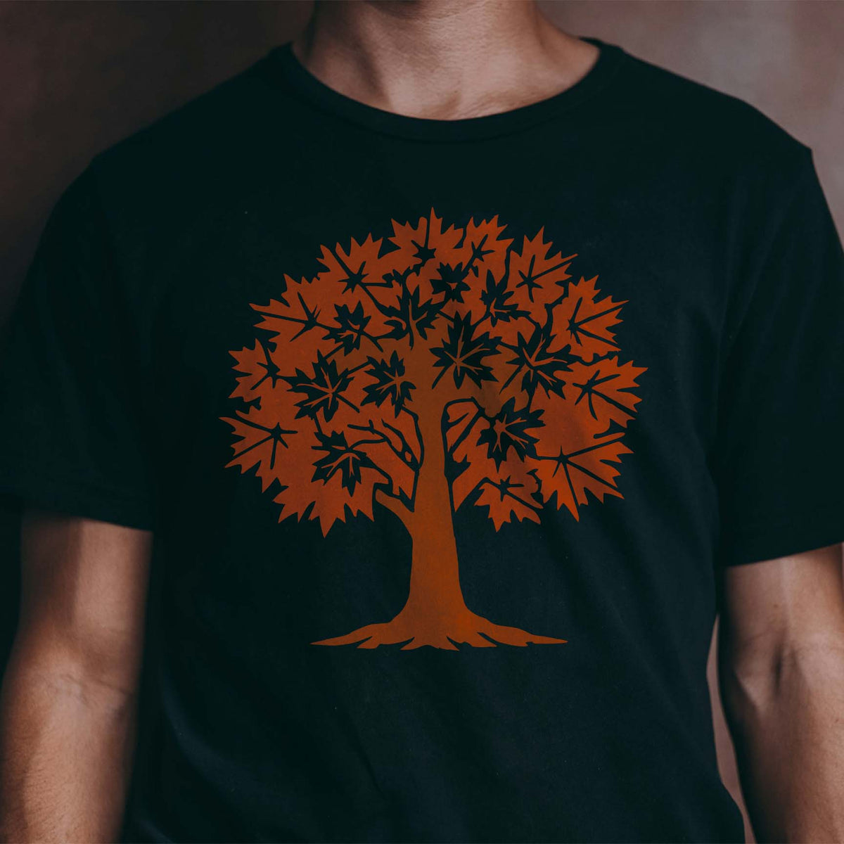 Maple Tree stencil with orange autumn leaves displayed on black shirt