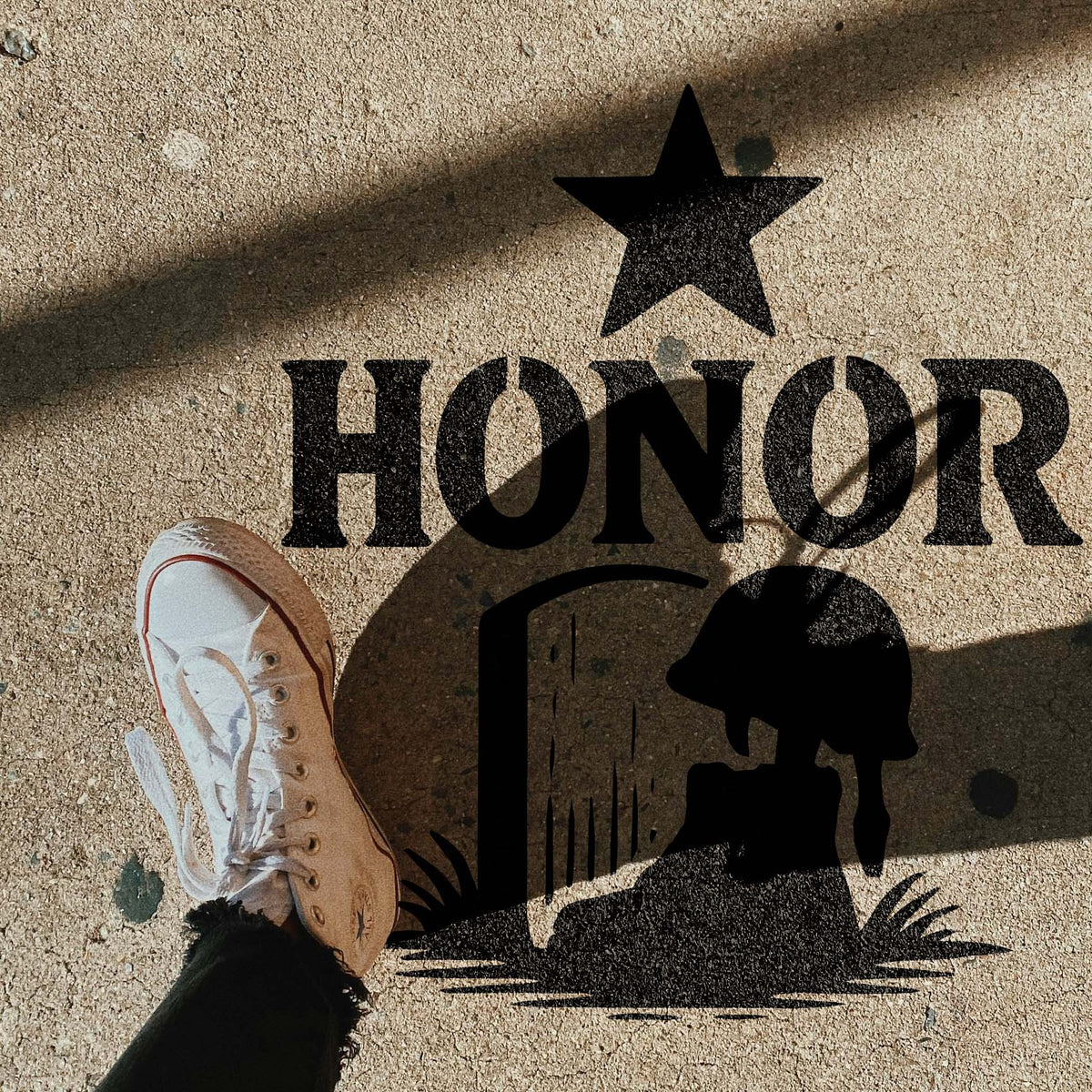 On a sunlit sidewalk, the Military Honor Memorial Stencil features bold HONOR lettering and a fallen soldier tribute.