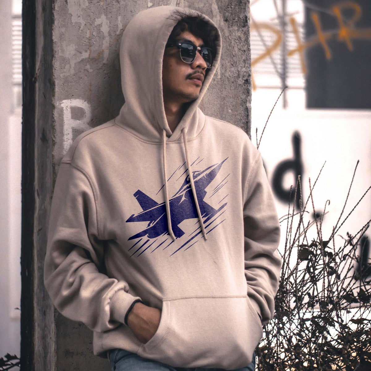 Modern Fighter Jet Silhouette Stencil printed in blue on a beige hoodie