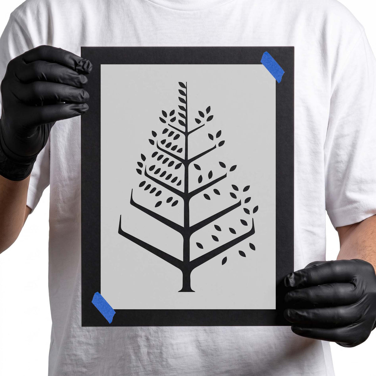 Modern tree stencil with geometric branches and scattered leaf shapes