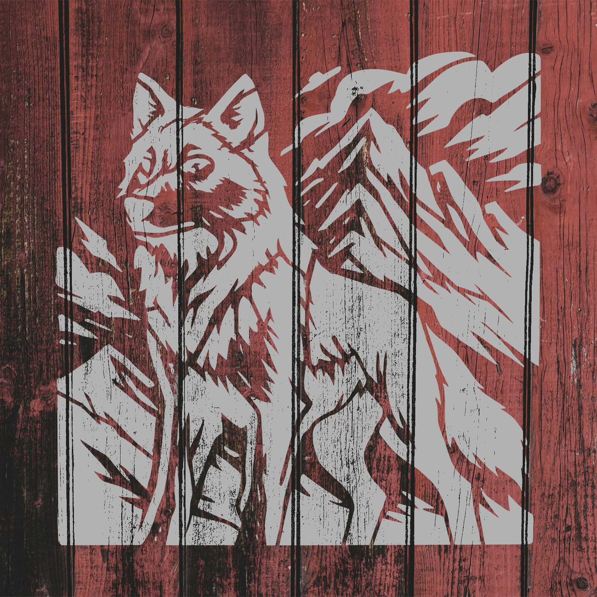 Mountain Wolf Wilderness Stencil creates a rustic white wolf and alpine scene across red wood planks.
