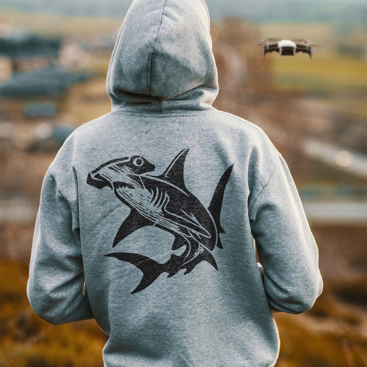A striking Ocean Hammerhead Shark Stencil spans the back of a gray hoodie