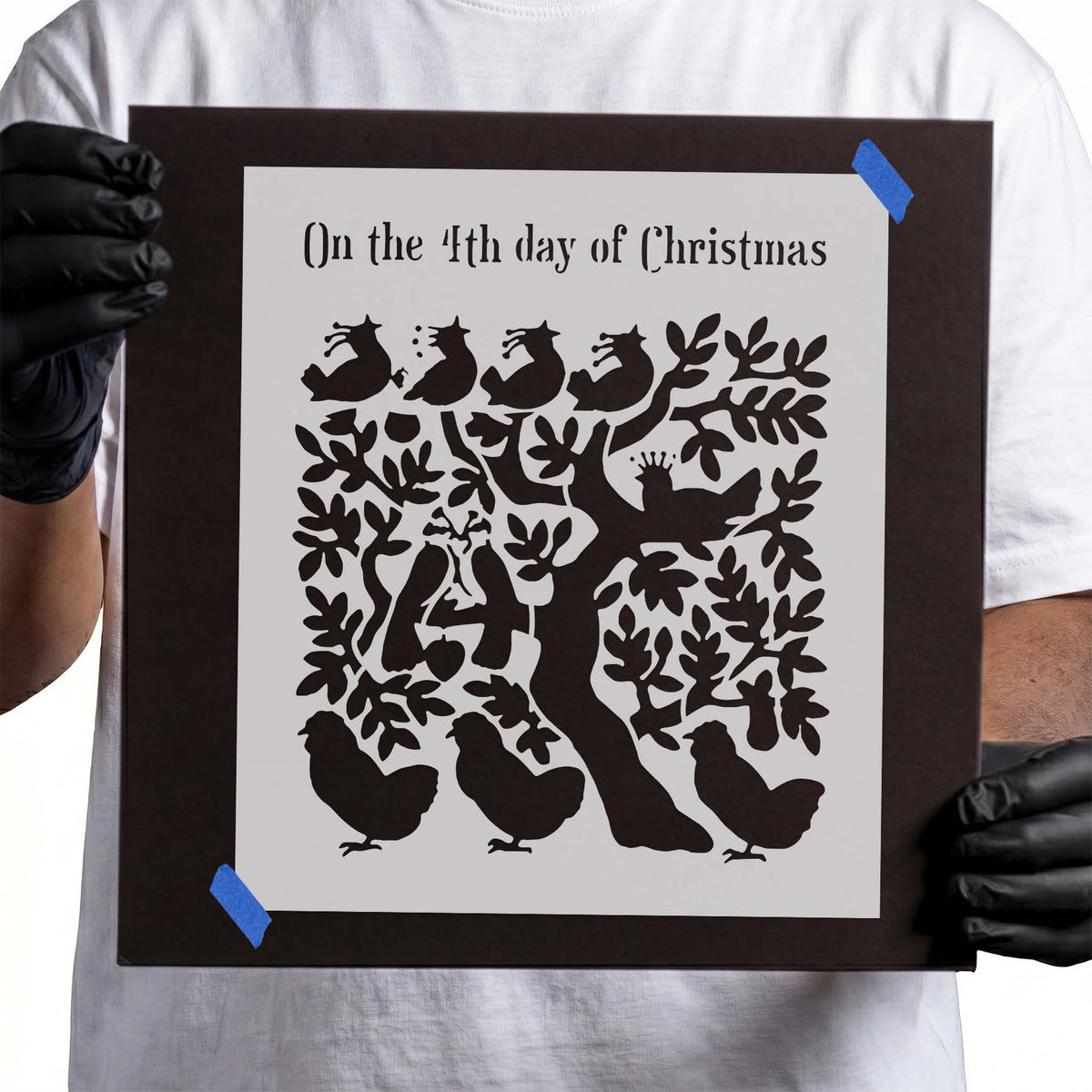 Christmas stencil with calling birds nestled among leafy tree branches