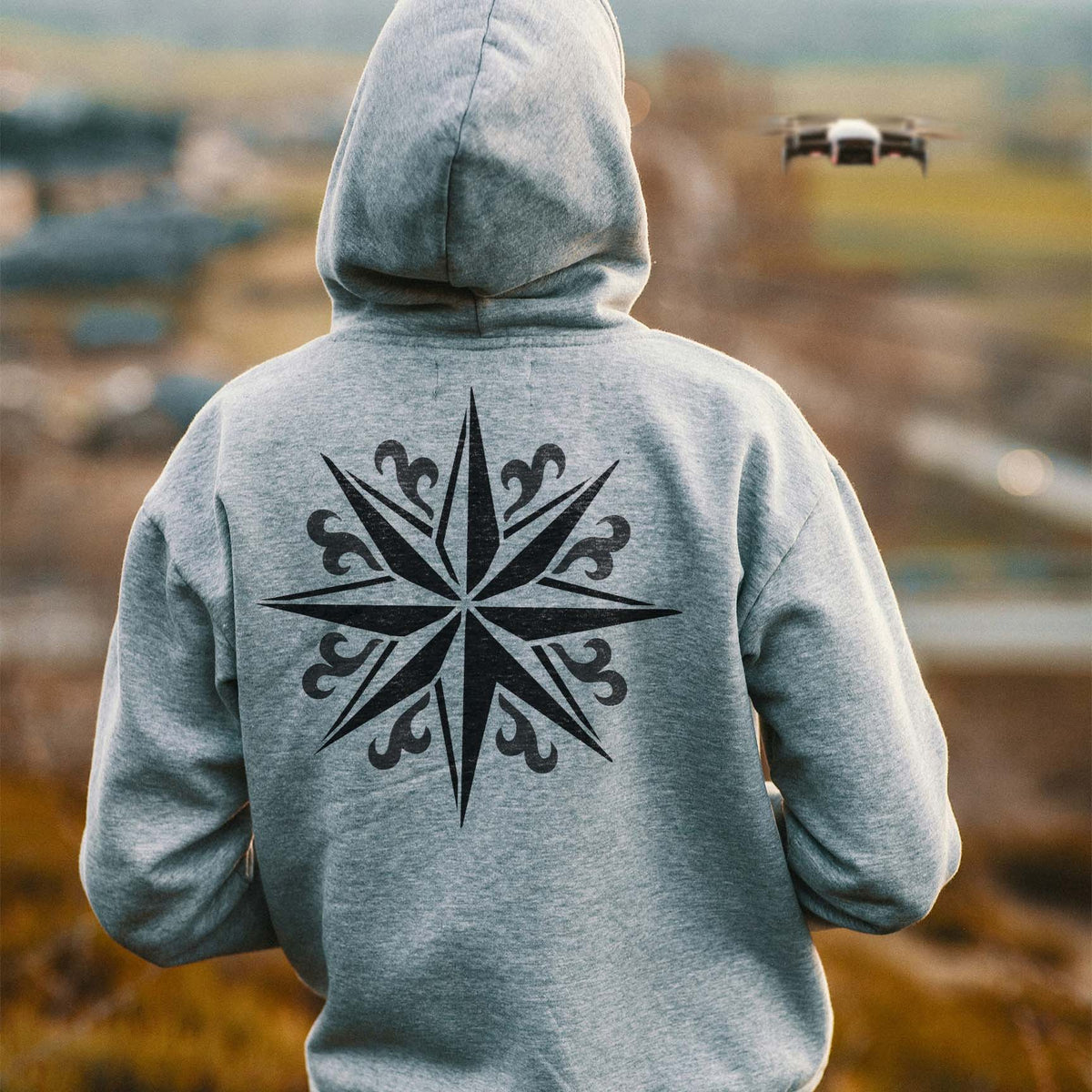 A gray hoodie features the Ornate Compass Star Stencil across the back in bold black