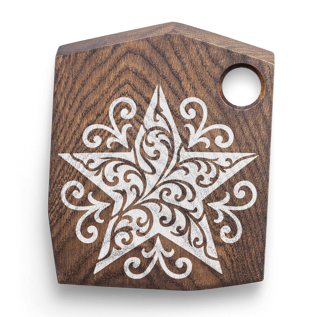 White Ornate Filigree Star Stencil decorates a dark wooden cutting board with swirling detail