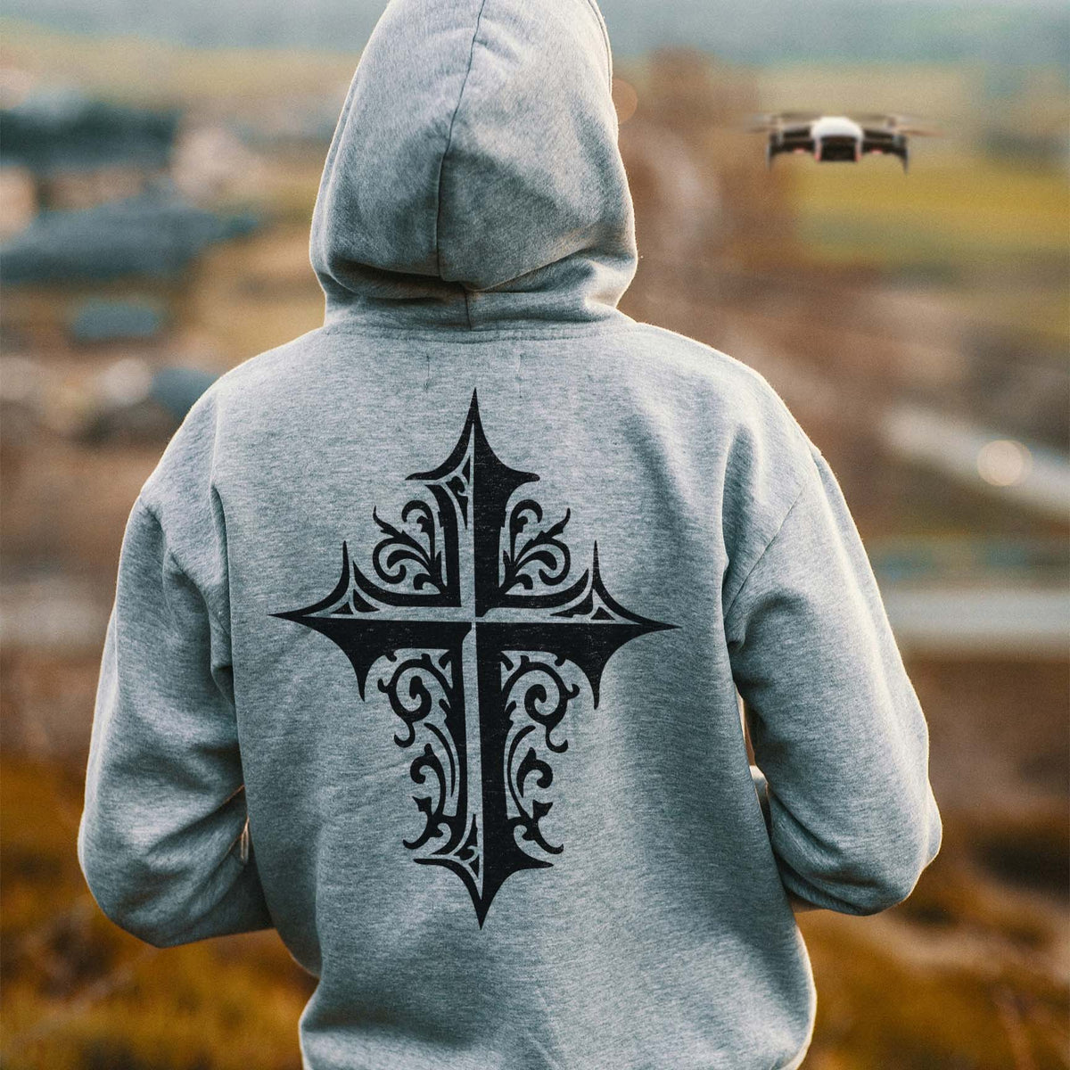 Gray hoodie displays the Ornate Gothic Cross Stencil with intricate black scrollwork