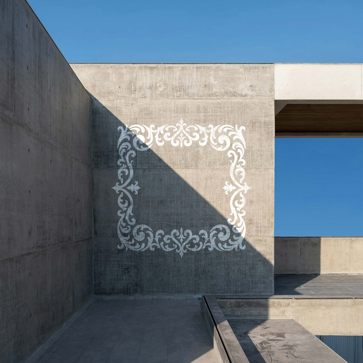 White Ornate Gothic Filigree Border Stencil stands out across a modern concrete wall