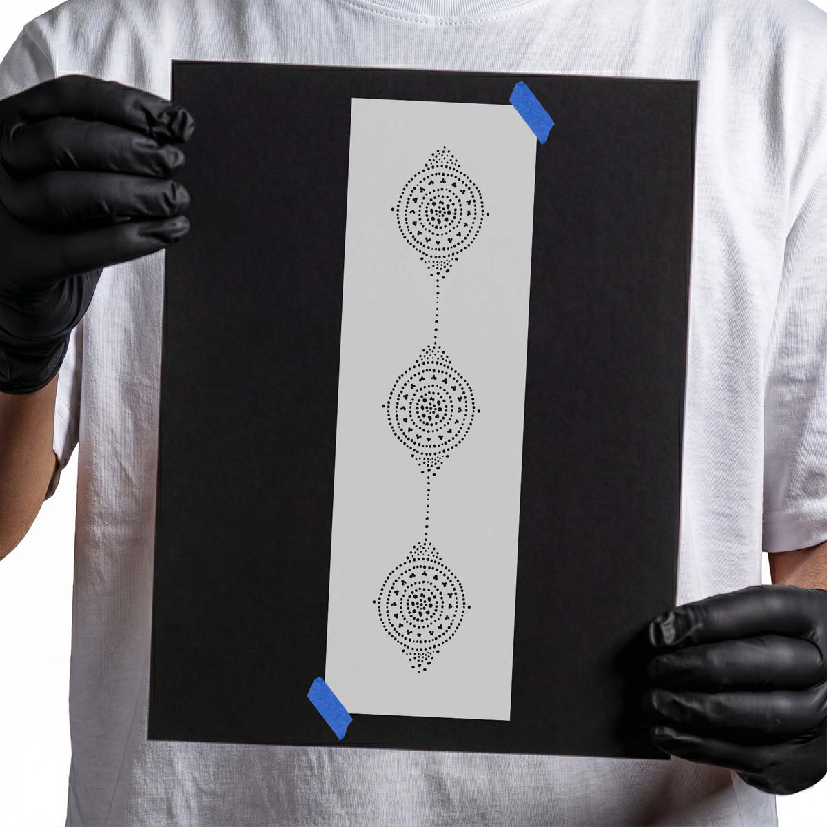 Three vertical ornate circles stencil formed with concentric dots and decorative details
