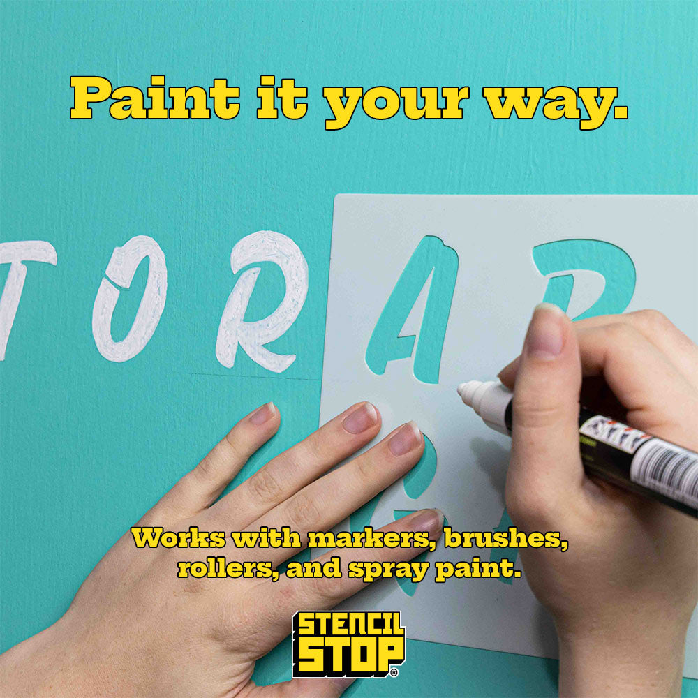 alphabet stencil being put on a wall with a paint pen