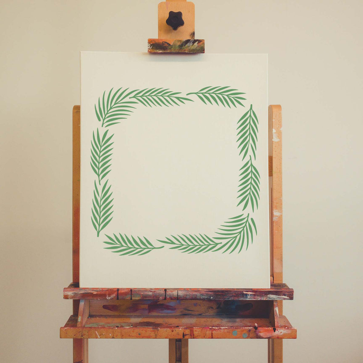 Palm Frond Border Stencil frames a blank canvas with soft green tropical leaves